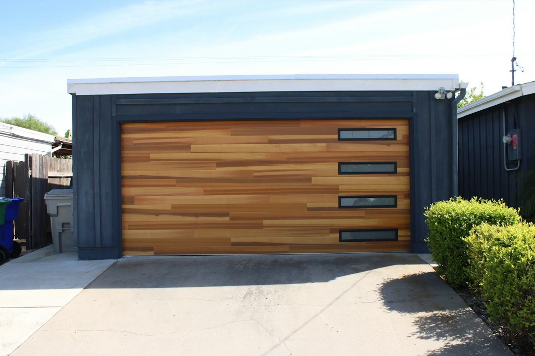 Modern wood panel garage door with windows